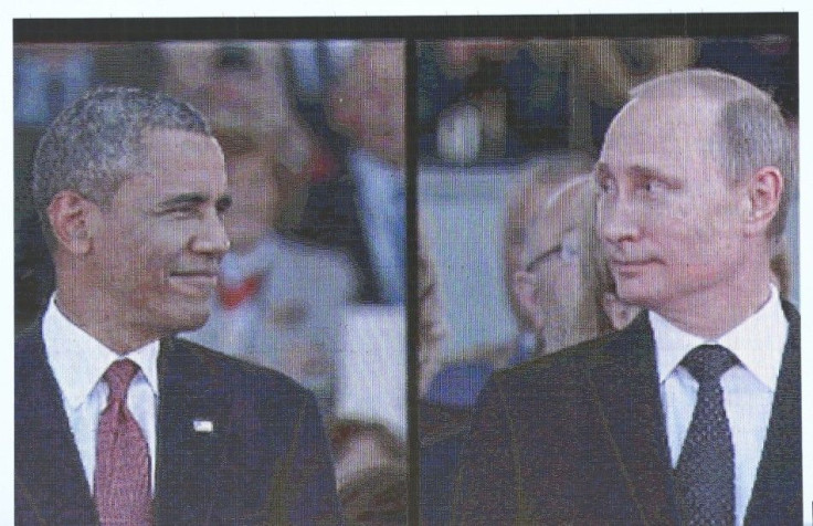 A huge video screen on Sword Beach shows U.S. President Barack Obama and Russian President Vladimir Putin as they arrive for the International 70th D-Day Commemoration Ceremony in Ouistreham June 6, 2014. World leaders and veterans gathered by the beaches