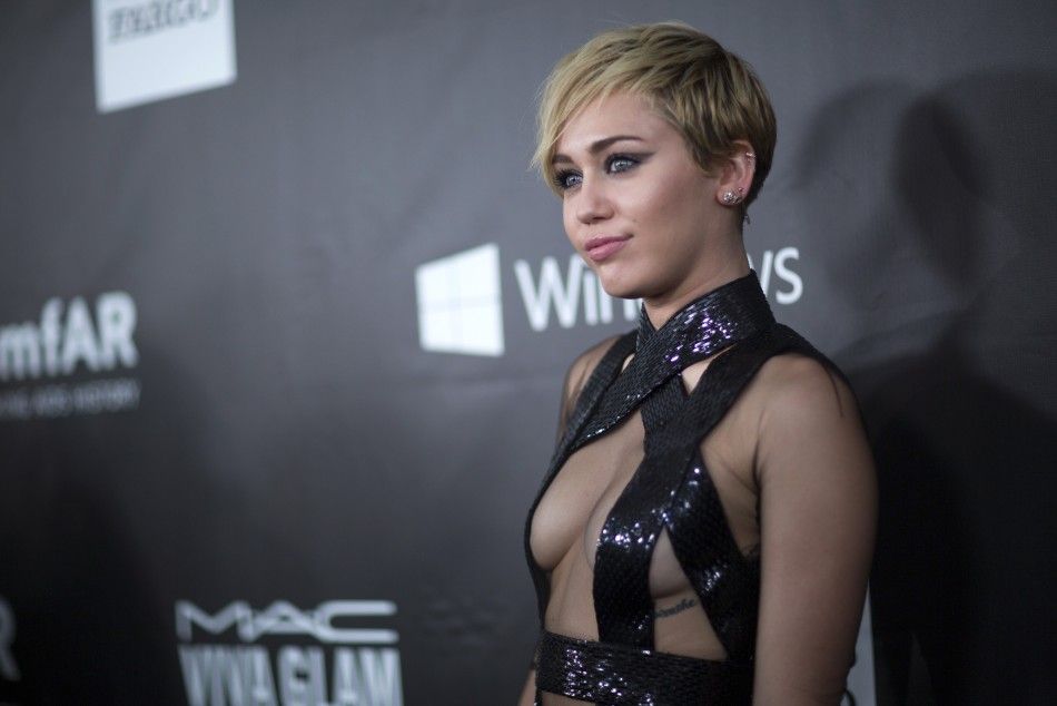 Singer Miley Cyrus poses at the amfARs Fifth Annual Inspiration Gala in Los Angeles, California