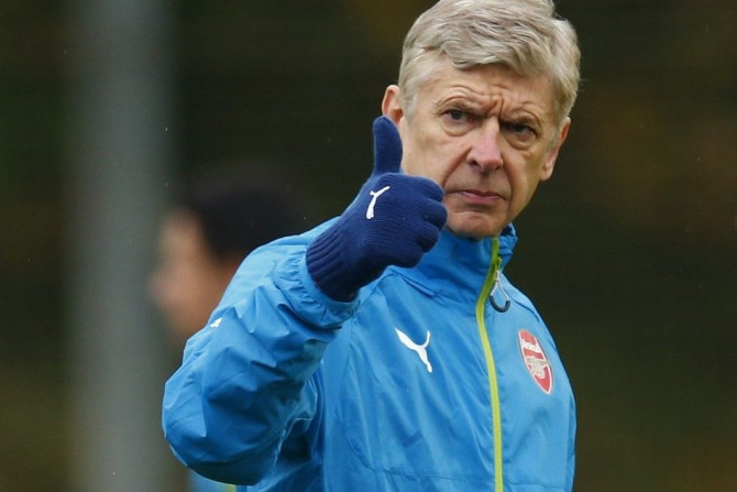 Arsenal manager Arsene Wenger gestures during a training session ahead of their Champions League soccer match against Borussia Dortmund, at their training facility in London Colney, north of London November 25, 2014.
