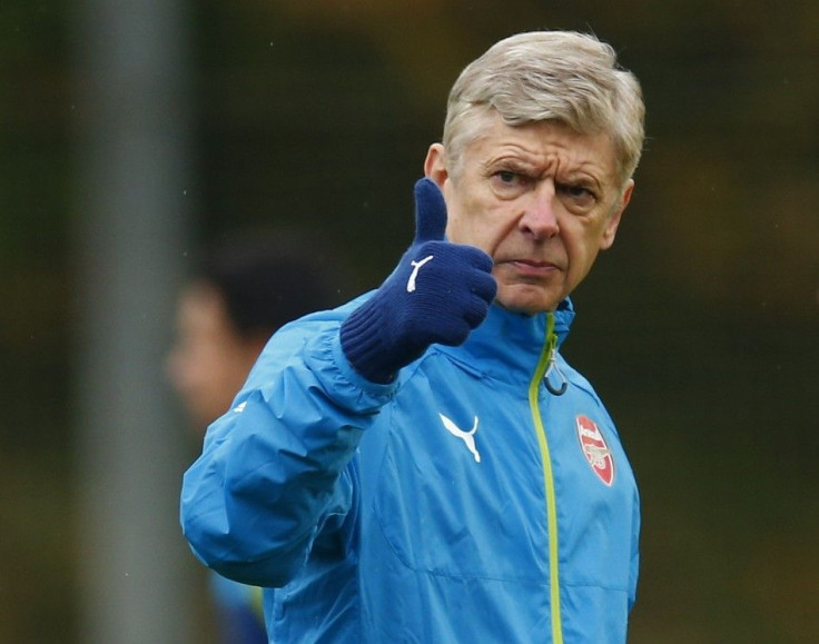 Arsenal manager Arsene Wenger gestures during a training session ahead of their Champions League soccer match against Borussia Dortmund, at their training facility in London Colney, north of London November 25, 2014.