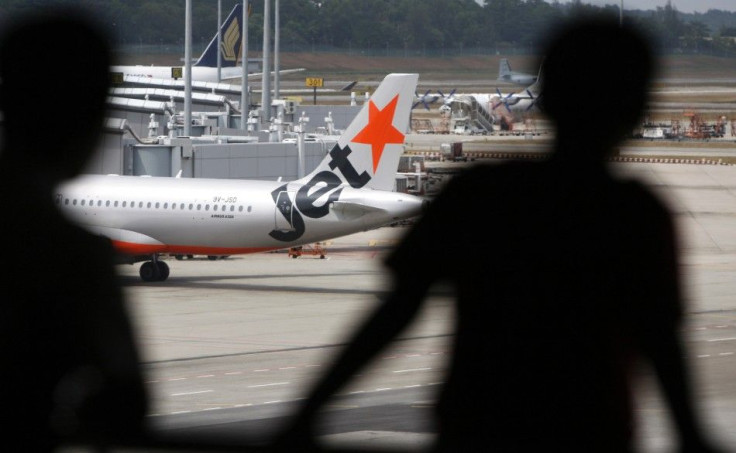 People look at a Jetstar aircraft from a viewing gallery at Singapore's Changi Airport February 10, 2009. The low cost airlines world conference will be held in Singapore on Wednesday. REUTERS/Vivek Prakash