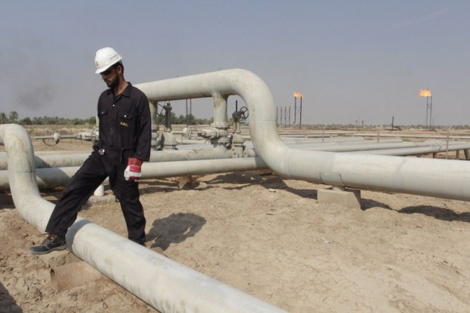 A worker walks at the Nahr Bin Umar field, north of Basra, southeast of Baghdad, November 16, 2014. OPEC producer Iraq expects to base its 2015 budget on an oil price of $80 per barrel, Oil Minister Adel Abdel Mehdi told parliament on Monday. Picture take