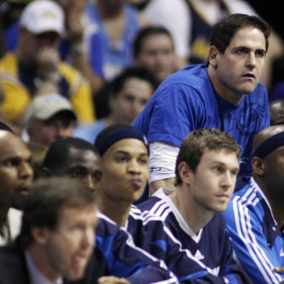 Dallas Mavericks owner Mark Cuban (top R) looks on late in Game 1 of the NBA Western Conference semi-final basketball playoffs against the Denver Nuggets in Denver May 3, 2009. The Nuggets defeated the Mavericks.