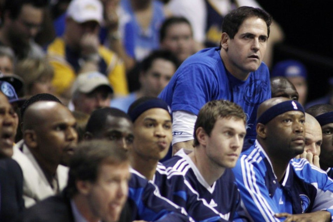 Dallas Mavericks owner Mark Cuban (top R) looks on late in Game 1 of the NBA Western Conference semi-final basketball playoffs against the Denver Nuggets in Denver May 3, 2009. The Nuggets defeated the Mavericks.