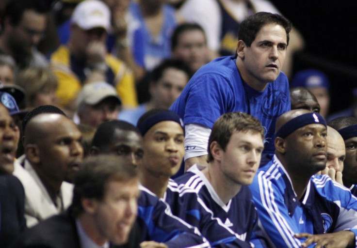 Dallas Mavericks owner Mark Cuban (top R) looks on late in Game 1 of the NBA Western Conference semi-final basketball playoffs against the Denver Nuggets in Denver May 3, 2009. The Nuggets defeated the Mavericks.