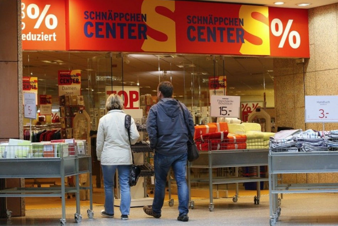 Shoppers walk in a Karstadt hot deal department store in Frankfurt/Oder October 24, 2014. Struggling German department store chain Karstadt is aiming for an operating profit margin of between 2.5 and 3 percent in 2017, its new chief executive was quoted s