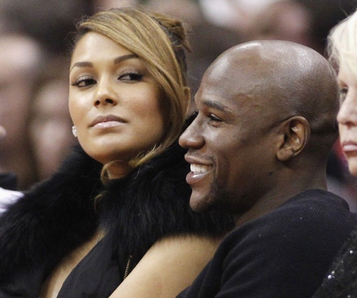 U.S. boxer Floyd Mayweather Jr. (R) sits with Shantel Jackson (L) courtside at the NBA basketball game between the Chicago Bulls and Los Angeles Clippers in Los Angeles December 30, 2011.