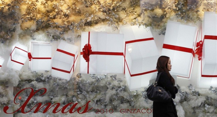 A woman walks past a window displaying Christmas decorations outside a department store in Tokyo November 25, 2010. Retailers across Australia and Japan are bracing for tight fisted shoppers to hold out for bargains in the lead-up to the ciritical holiday
