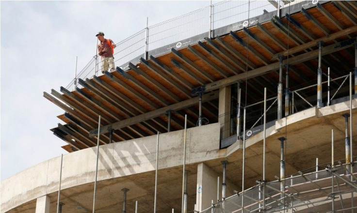 A construction worker looks over the top of Queensland Terrace