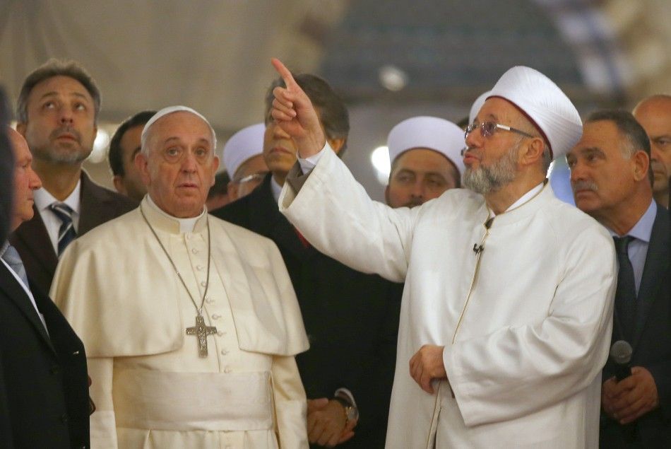 Pope Francis listens to Rahmi Yaran, Mufti of Istanbul R during a visit to Sultan Ahmet mosque, popularly known as the Blue Mosque in Istanbul November 29, 2014. Pope Francis began a visit to Turkey on Friday with the delicate mission of strengthening t