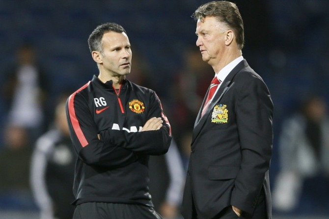 Manchester United manager Louis van Gaal (R) and assistant Ryan Giggs chat ahead of their team's English Premier League soccer match against West Bromwich Albion at The Hawthorns in West Bromwich October 20, 2014.