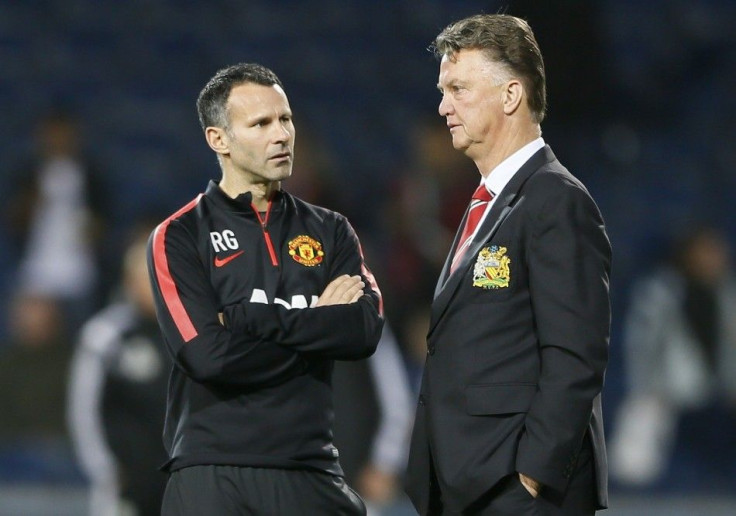 Manchester United manager Louis van Gaal (R) and assistant Ryan Giggs chat ahead of their team's English Premier League soccer match against West Bromwich Albion at The Hawthorns in West Bromwich October 20, 2014.