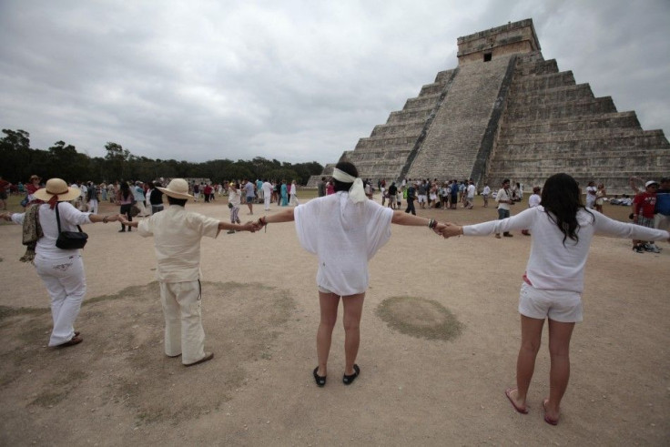Visitors and tourists make a human chain around the pyramid of Kukulkan at the archaeological site of Chichen Itza in Yucatan State, December 21, 2012. Thousands of mystics, hippies and tourists celebrated in the sunshine of southeastern Mexico on Friday 