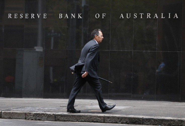 A businessman walks past the Reserve Bank of Australia in Sydney February 4, 2014. Australia's central bank kept its main cash rate at a record low of 2.5 percent on Tuesday as widely expected but surprised some by saying further cuts were not in the card