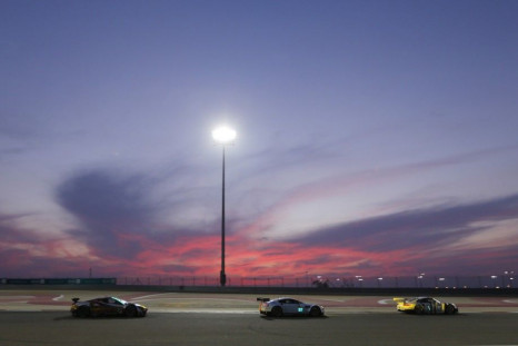Cars race during at sunset during the Six Hours of Bahrain race, part of the World Endurance Championship (WEC), at the Bahrain International Circuit in Sakhir south of Manama, November 15, 2014. REUTERS/Hamad I Mohammed