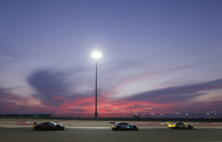 Cars race during at sunset during the Six Hours of Bahrain race, part of the World Endurance Championship (WEC), at the Bahrain International Circuit in Sakhir south of Manama, November 15, 2014. REUTERS/Hamad I Mohammed