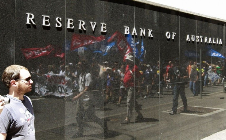 A man looks at protestors of the &quot;Occupy Sydney&quot; movement as they march in front of the Reserve Bank of Australia in central Sydney November 5, 2011. Hundreds of protesters gathered on Saturday against economic inequality.