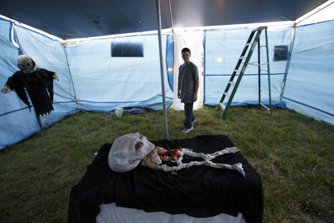 Jacob Martin tours an alien autopsy tent during the opening night of a festival celebrating the supposed visit of aliens to the Kelly-Hopkinsville area in 1955, in Kelly, Kentucky August 16, 2013.