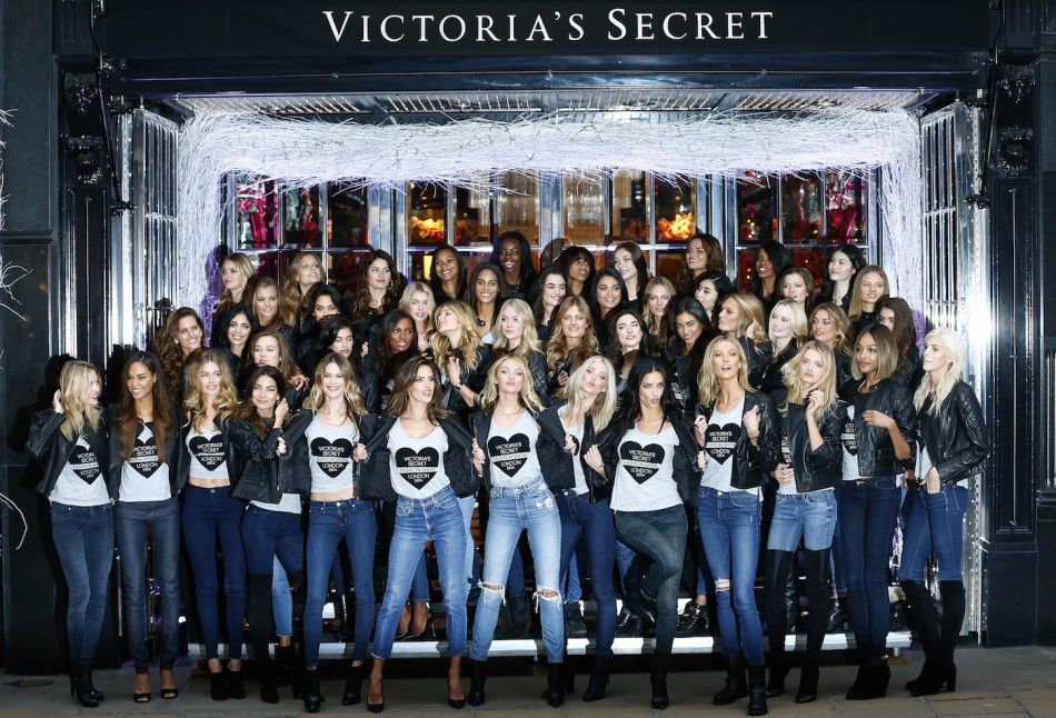 Models pose for a group photograph outside the Victorias Secret shop on New Bond Street