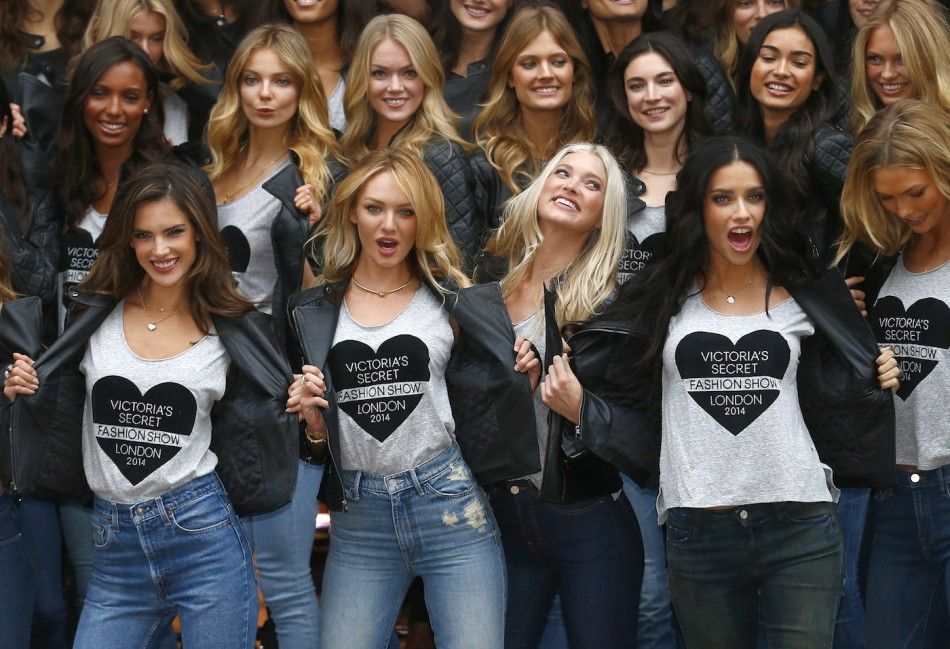 Models pose for a group photograph outside the Victorias Secret shop on New Bond Street in central London