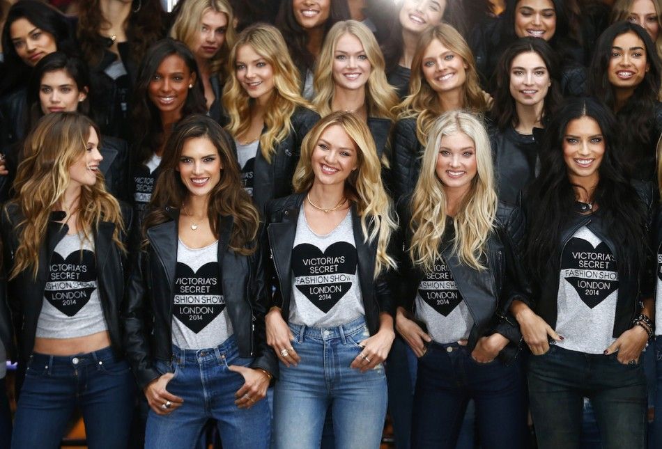 Models pose for a group photograph outside the Victorias Secret shop on New Bond Street in central London