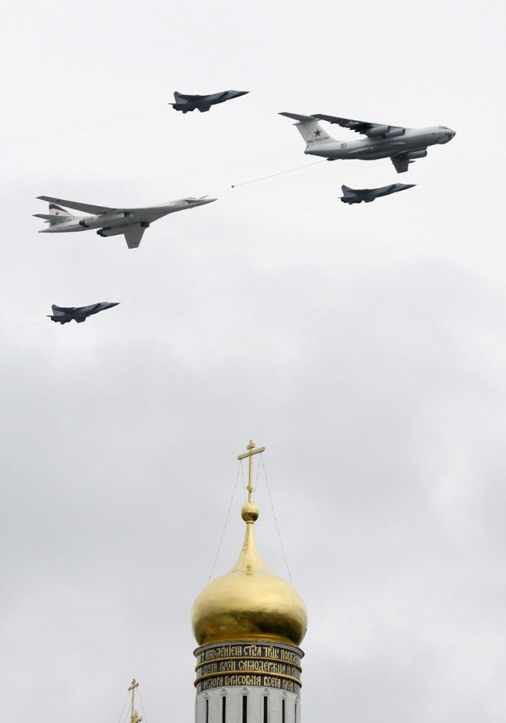 A Tupolev Tu-160 bomber, an Ilyushin Il-78 refueling tanker and three MiG-31 fighter jets fly in formation over Red Square and the Kremlin during a military parade dress rehearsal in Moscow May 6, 2010.