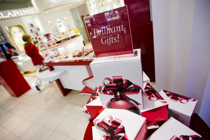 A woman walks behind a Christmas display that reads &quot;Brilliant Gifts&quot; at a shopping mall in Toronto, December 7, 2012.