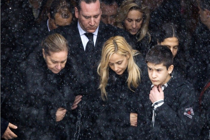 The family of Nick Rizzuto leaves the church following his funeral in Montreal