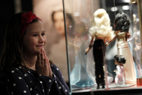 A girl looks at Barbie dolls during a Barbie exhibition in Zagreb May 15, 2012.