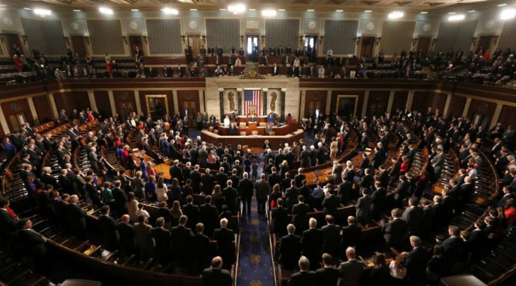 Members of the 113th Congress bow their heads in prayer as they convene in the Capitol in Washington January 3, 2013. In the wake of bruising fights in their own ranks over the &quot;fiscal cliff&quot; and aid for victims of superstorm Sandy - Republicans