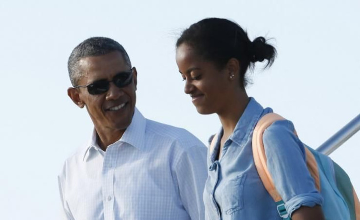 U.S. President Barack Obama and daughter Malia disembark from Air Force One upon arrival in Cape Cod before being flown to nearby Martha's Vineyard in Massachusetts, August 19, 2014. Obama is resuming to his summer vacation after returning to Washington f