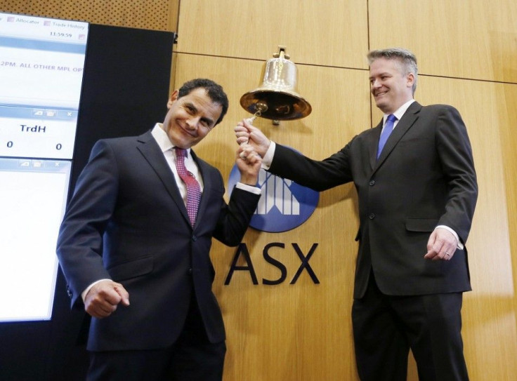 Australian Finance Minister Mathias Cormann (R) and Medibank Managing Director George Savvides ring the Australian Stock Exchange Bell to begin trading of Medibank stock in Sydney November 25, 2014. Australian health insurer Medibank Private Ltd, which ra