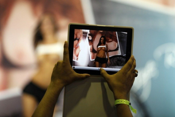 A visitor takes a picture of a porn actress with his Ipad during the Sex and Entertainment 2012 adult exhibition at the Palacio de los Deportes in Mexico City March 1, 2012.
