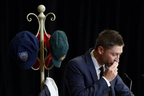 Australian cricket team captain Michael Clarke pauses as he speaks in front of he Baggy Green and other state representative caps belonging to Australian cricketer Phillip Hughes during his funeral service