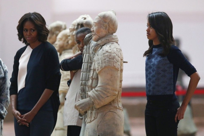 U.S. first lady Michelle Obama (L), her daughters Sasha (C) and Malia visit the Museum of Qin Terracotta Warriors and Horses, in Xi'an, Shaanxi province, March 24, 2014.