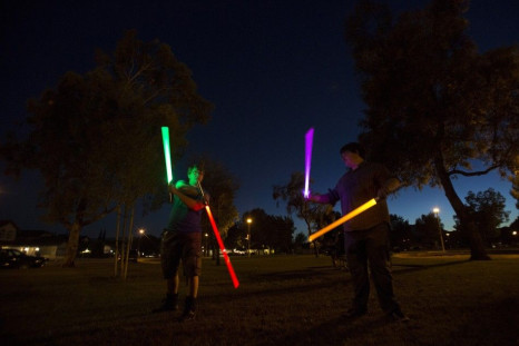 Enthusiasts Andrew Ewing (L) and Dimitri Sharbonneau use lightsabers