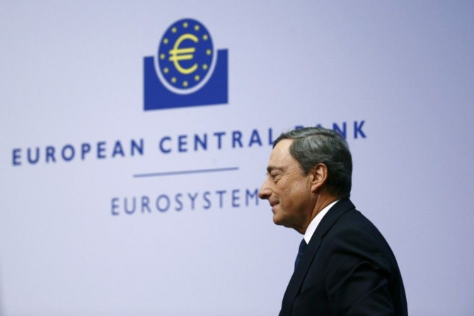 European Central Bank (ECB) President Mario Draghi leaves after addressing an ECB news conference December 4, 2014, for the first time in the ECB's new 1.3 billion euro headquarters in Frankfurt. Draghi said on Thursday the bank would reassess the impact 