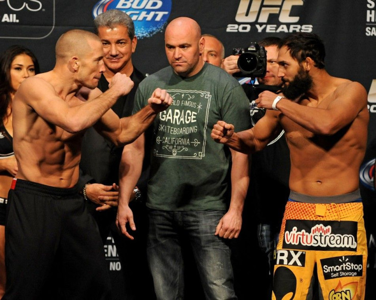 Nov 15, 2013; Las Vegas, NV, USA; UFC 167 Welterweight challenger Georges St. Pierre (left) and welterweight champion Johny Hendricks pose for photographs with UFC president Dana White during the official weigh-in of UFC 167 at MGM Grand Garden Arena.