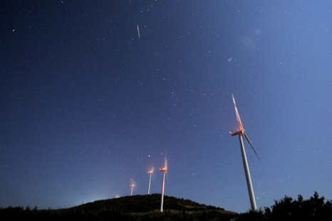 A meteor streaks over the sky during the Perseid meteor shower at a windmill farm near Bogdanci, south of Skopje in the early morning August 13, 2014. The annual Perseid meteor shower reaches its peak on August 12 and 13 in Europe, although the lunar glar