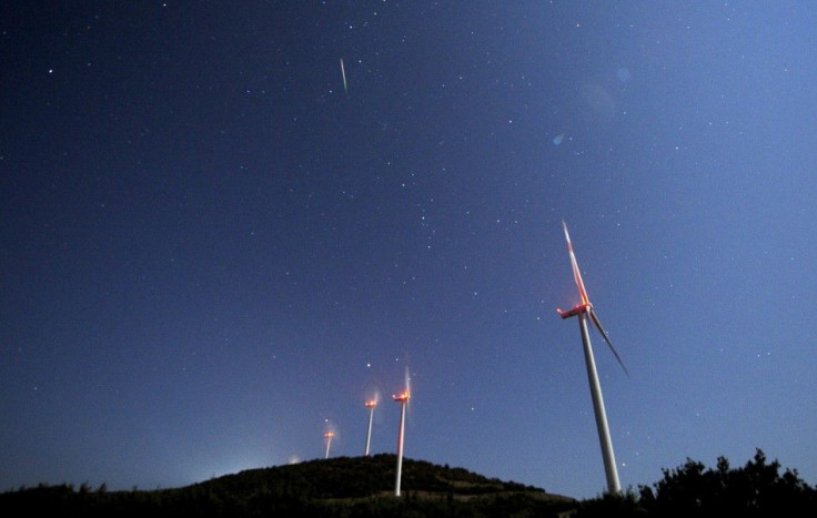 A meteor streaks over the sky during the Perseid meteor shower at a windmill farm near Bogdanci, south of Skopje in the early morning August 13, 2014. The annual Perseid meteor shower reaches its peak on August 12 and 13 in Europe, although the lunar glar