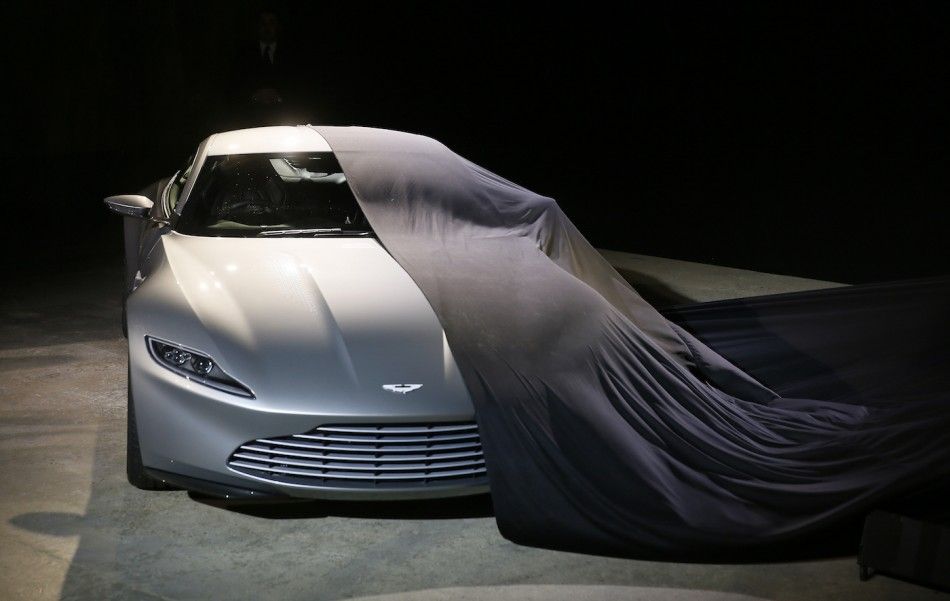 An Aston Martin DB10 car is unveiled on stage 