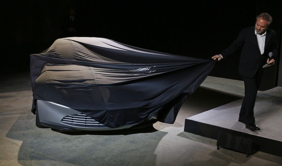 An Aston Martin DB10 car is unveiled on stage 