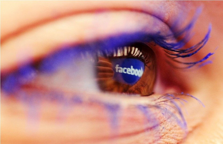 A Facebook logo reflected in the eye of a woman