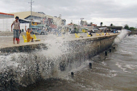 Waves, brought by Typhoon Hagupit, hit the concrete barrier along the Boulevard Seaport in Surigao City, southern Philippines December 6, 2014. More than half a million people in the Philippines have fled from Typhoon Hagupit in one of the world's biggest