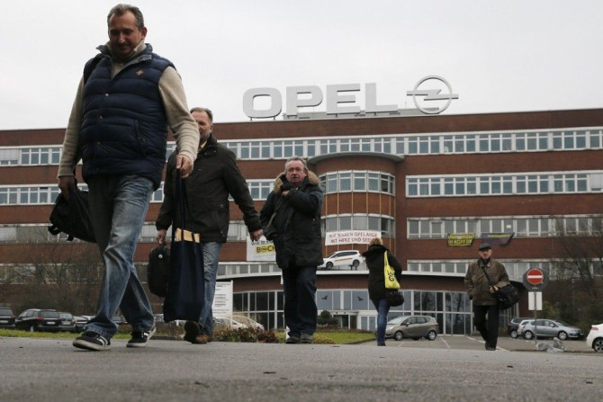 Staff walk in front of the Opel Plant during a shift change on its final day of production in Bochum December 5, 2014. European carmaker Opel closed its Bochum plant on Friday.