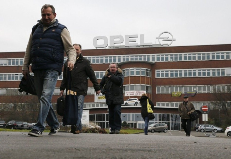 Staff walk in front of the Opel Plant during a shift change on its final day of production in Bochum December 5, 2014. European carmaker Opel closed its Bochum plant on Friday.