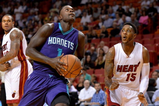 Nov 23, 2014; Miami, FL, USA; Charlotte Hornets guard Lance Stephenson (1) drives to the basket as Miami Heat guard Mario Chalmers (15) defends during the first half at American Airlines Arena. 