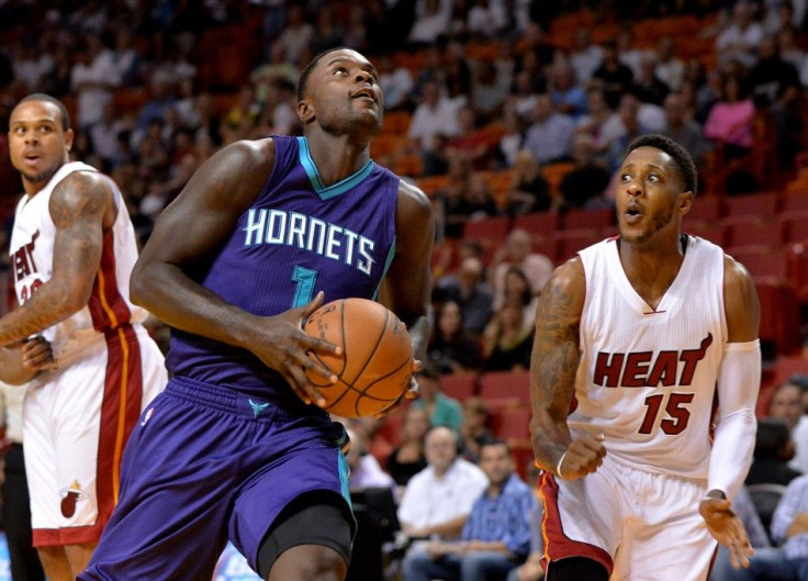 Nov 23, 2014; Miami, FL, USA; Charlotte Hornets guard Lance Stephenson (1) drives to the basket as Miami Heat guard Mario Chalmers (15) defends during the first half at American Airlines Arena. 