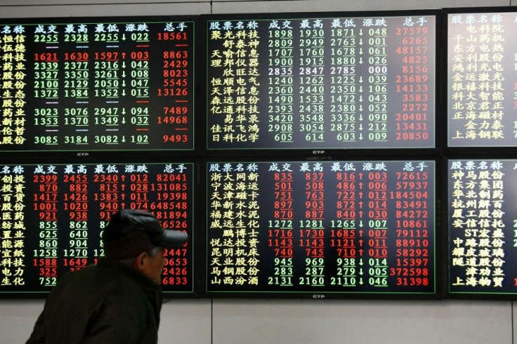 An investor looks at information displayed on an electronic screen at a brokerage house in Shanghai, December 8, 2014. Asian stocks eked out gains on Monday in wake of much stronger-than-expected U.S. employment numbers, although sobering data highlighted