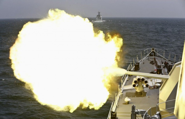 A Chinese navy vessel fires its cannon during the Joint Sea-2014 naval drill outside Shanghai on the East China Sea, May 24, 2014. Chinese and Russian navies staged exercises on the East China Sea on Saturday to simulate anti-submarine and search-and-resc